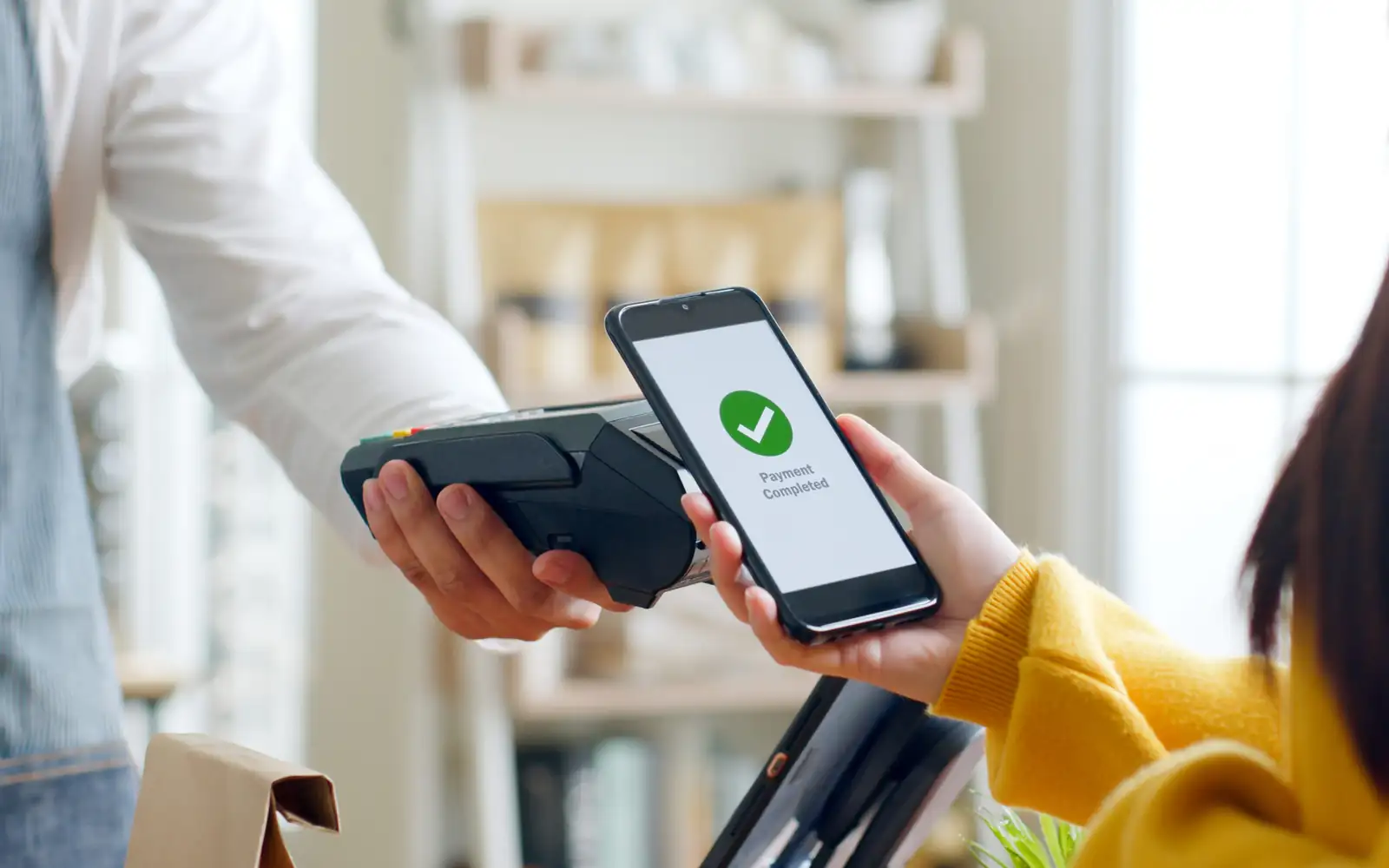 Customer using smartphone for NFC payment at cafe restaurant, ca